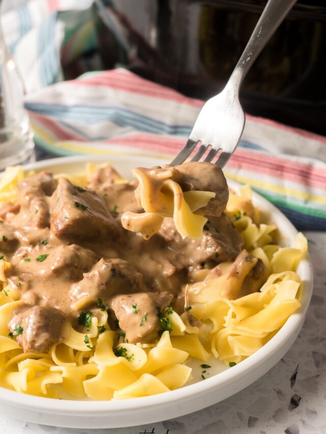 crockpot beef tips and noodles on fork