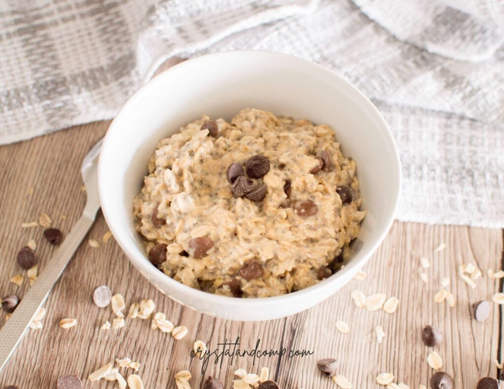 cookie dough overnight oats in bowl with towel with chocolate chips on table