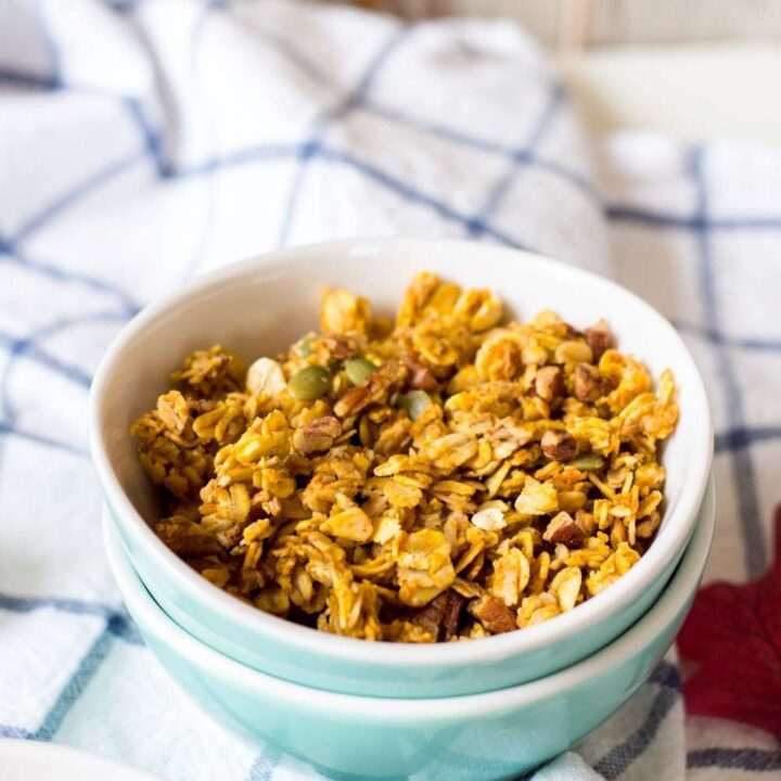 pumpkin granola in two bowls on towel