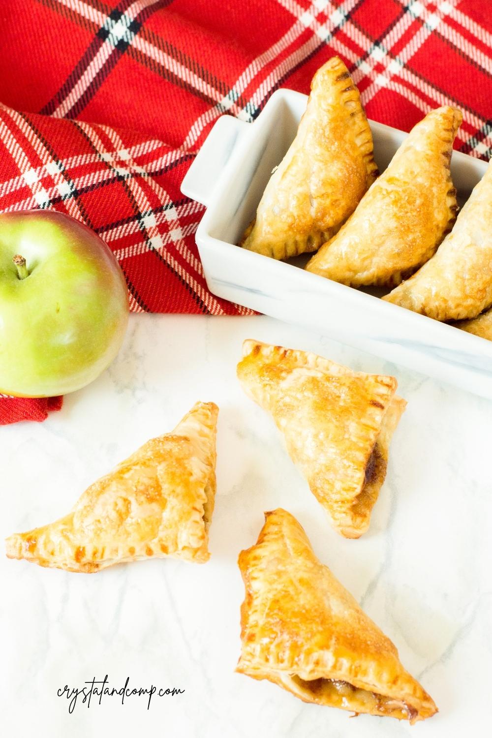 apple turnovers on marble with fruit