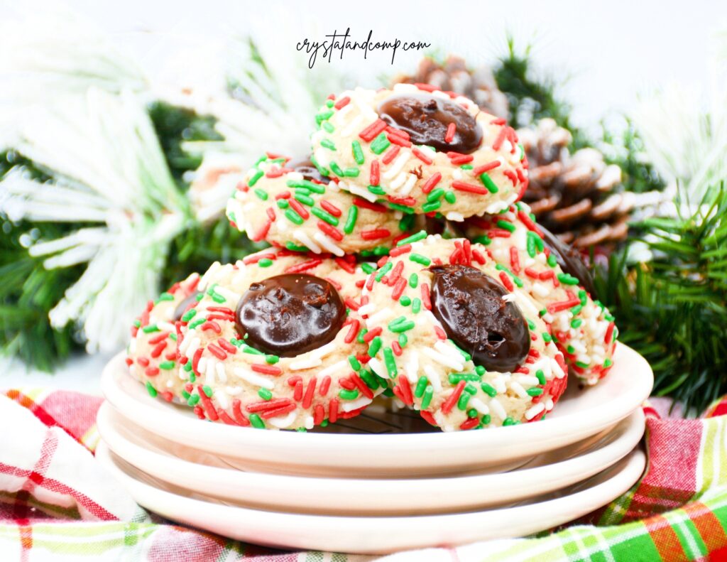 christmas sprinkle thumbprint cookies on plates