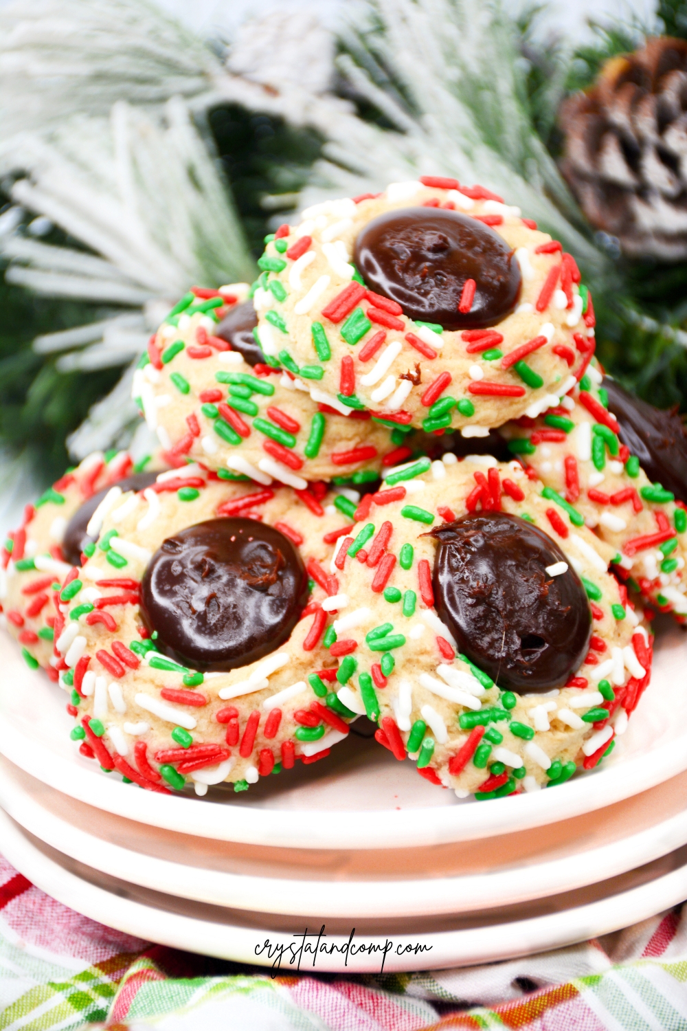 christmas sprinkle thumbprint cookies with greenery