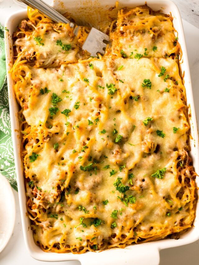 spaghetti casserole in pan with green towel