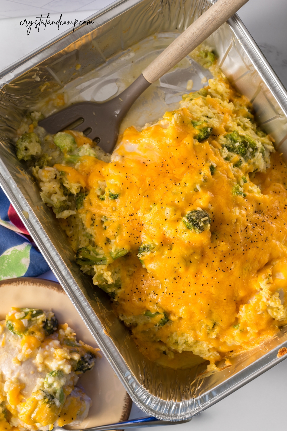 chicken broccoli rice casserole in pan with spatula